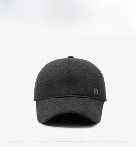 Detail of dark grey wool blend baseball cap with side metal logo plaque for men