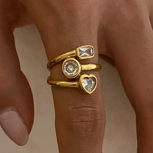 Detail of gold open ring featuring heart, round, and rectangular zircon stones
