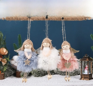 Three plush Christmas angel ornaments with wooden faces and sparkling wings on blue background