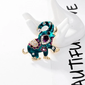 Ethnic elephant brooch with blue enamel inlay and sparkling crystals on gold alloy