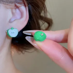 Green apple shape asymmetric stud earrings in silver with a minimalist enamel finish