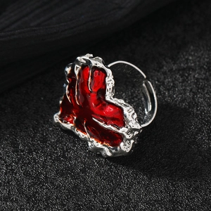 Minimalist red heart ring with silver lava texture on dark matte background