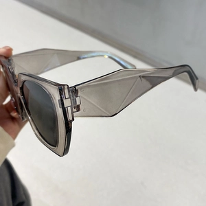 Modern oversized geometric sunglasses with translucent taupe frames and grey lenses