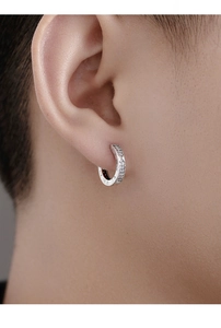 Close-up of model wearing silver Roman numeral earrings with embedded small diamonds