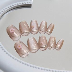 Cat eye press-on nails with camellia flowers and pearls on a mirror background