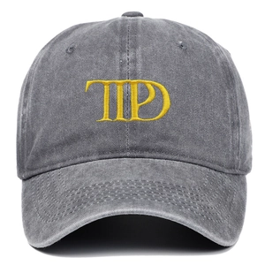 Close-up of TTPD yellow embroidery on a gray washed vintage style baseball cap