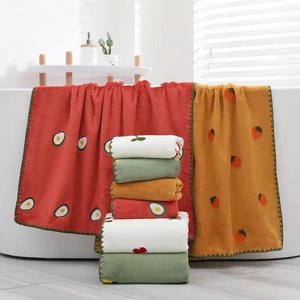 Soft coral fleece embroidered towel set featuring cute fruit patterns in a bathroom setting