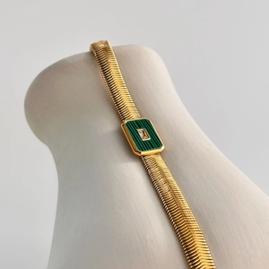 Close-up of 18k gold plated snake chain bracelet with green malachite pendant and zircon