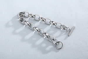 Detail of silver titanium steel chain bracelet with minimalist toggle clasp closure