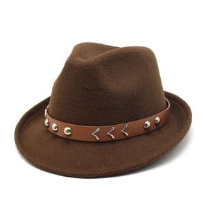 Detail of dark brown wool fedora hat featuring a leather band with metal stud accents
