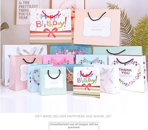 Set of assorted paper gift bags with floral patterns and striped designs in various sizes