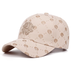 Detail of premium golden 3D embroidery and monogram pattern on beige baseball cap