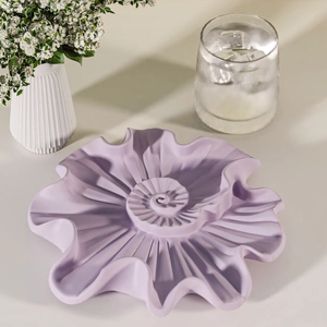 Modern spiral shell-shaped jewelry tray in light purple for home storage and decor