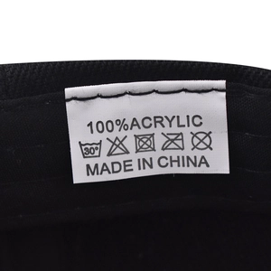 Detail shot of the 100% acrylic fabric label and washing care instructions on the hat