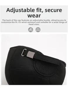 Detail of adjustable metal buckle and strap on back of black winter baseball cap
