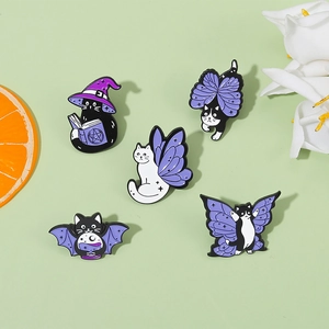 Macro detail of high-quality enamel magic cat pins with witch hats and wings