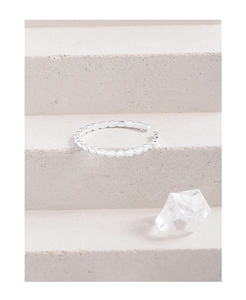Detailed close-up of S925 sterling silver beaded open ring on a textured stone surface