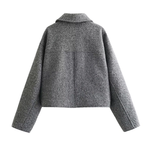 Back view of a cropped grey tweed jacket showing rich textured fabric and minimalist design