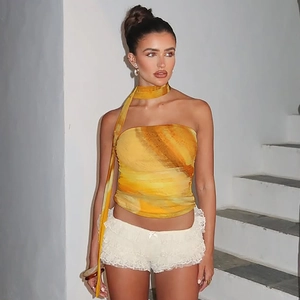 Détail d'un top bandeau dégradé jaune artistique avec un short à ourlet en dentelle