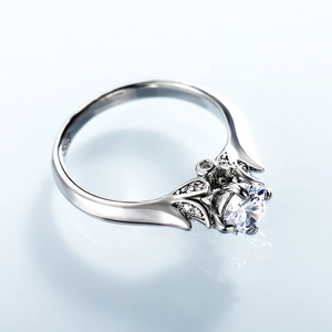 Classic four-prong cubic zirconia ring with leaf-shaped side stones on silver band