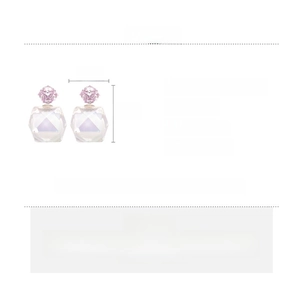 Detail view of geometric zircon earrings with size 2.5x1.5cm and material specs