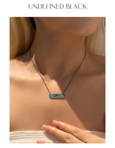 Detail of S925 silver black necklace with blue pavé rectangle and star cutout