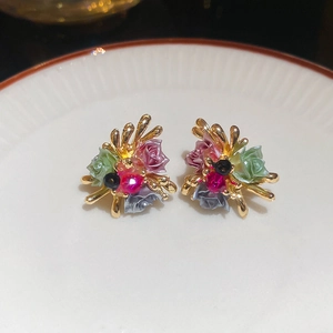 Close-up of vintage floral earrings with colorful resin petals and sparkling crystals