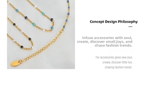 Detail of gold chain necklace featuring colorful enamel beads and a small metal oval tag