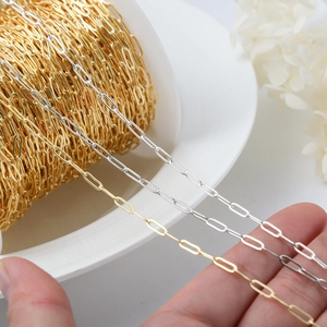 Macro detail of 14K gold and silver paperclip chain links for DIY jewelry making