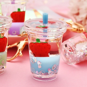 Cute strawberry milk tea cup keychain with floating strawberry and liquid glitters