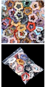 Close-up of mixed natural crystal hollow plum blossom pendants in clear packaging