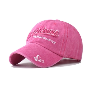 Macro shot of 3D embroidery and washed pink fabric texture on a vintage baseball cap