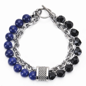 Detail of beaded bracelet with blue lapis beads, black faceted stone, and silver toggle clasp