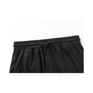 Detail of men's sports shorts featuring elastic waistband, drawstring and mesh fabric