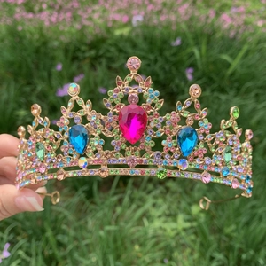 Detail of a baroque bridal crown with colorful rhinestones and gold metal finish