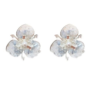 Elegant flower stud earrings with central pearl and sparkling zircon on white background