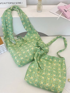 Floral print tote bag in soft green with bow straps shown in a lifestyle scene