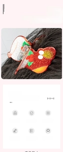 Detail of red glitter acrylic hair claw clip with festive holly berry motif on dark hair