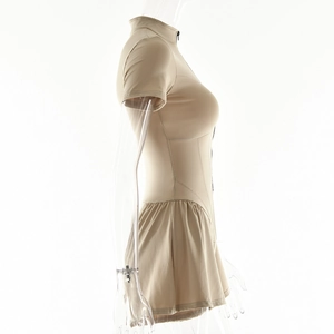 Side view of beige short sleeve romper featuring front zipper and pleated skirt detail