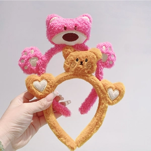 Detailed close-up of soft plush headbands featuring pink bear and yellow heart designs