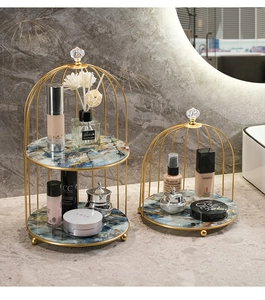 Detail of birdcage iron vanity rack with gold metal frame and marble texture base