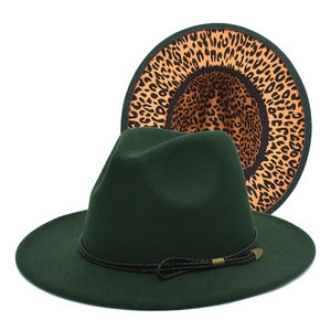 Detail of dark green fedora hat featuring leopard print lining and braided band accessory