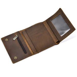 Detailed internal view of brown leather trifold wallet showing card slots and zipper pocket