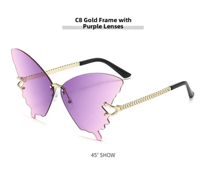 Detail of butterfly-shaped rimless sunglasses with purple gradient lenses and gold chain arms