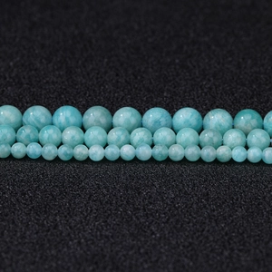 Natural amazonite round beads in three sizes for DIY jewelry making on black background