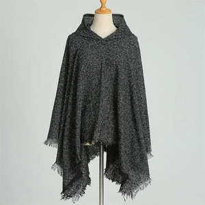 Detailed texture of dark grey faux cashmere hooded poncho with elegant fringe tassels