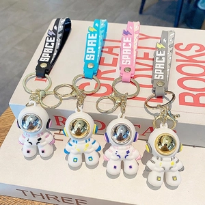 Cartoon astronaut keychain set in black, blue, pink, and grey with SPACE wrist straps