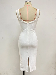 Detail view of the invisible zipper and back slit on a white velvet party dress