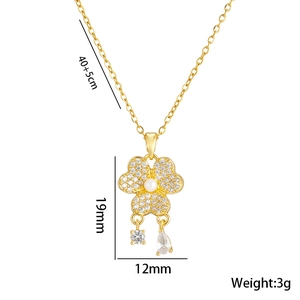 Gold titanium necklace with clover flower pearl pendant and cubic zirconia tassel details
