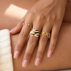 Three-piece gold stackable ring set with black enamel heart and rhinestone accents